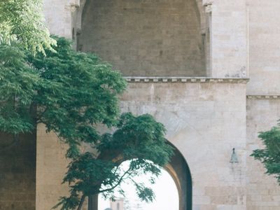 A person balancing on one leg in a bright space.