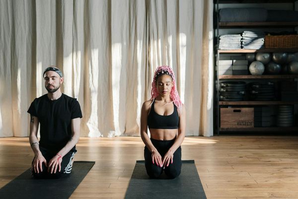 Person practicing yoga in a bright, modern studio.